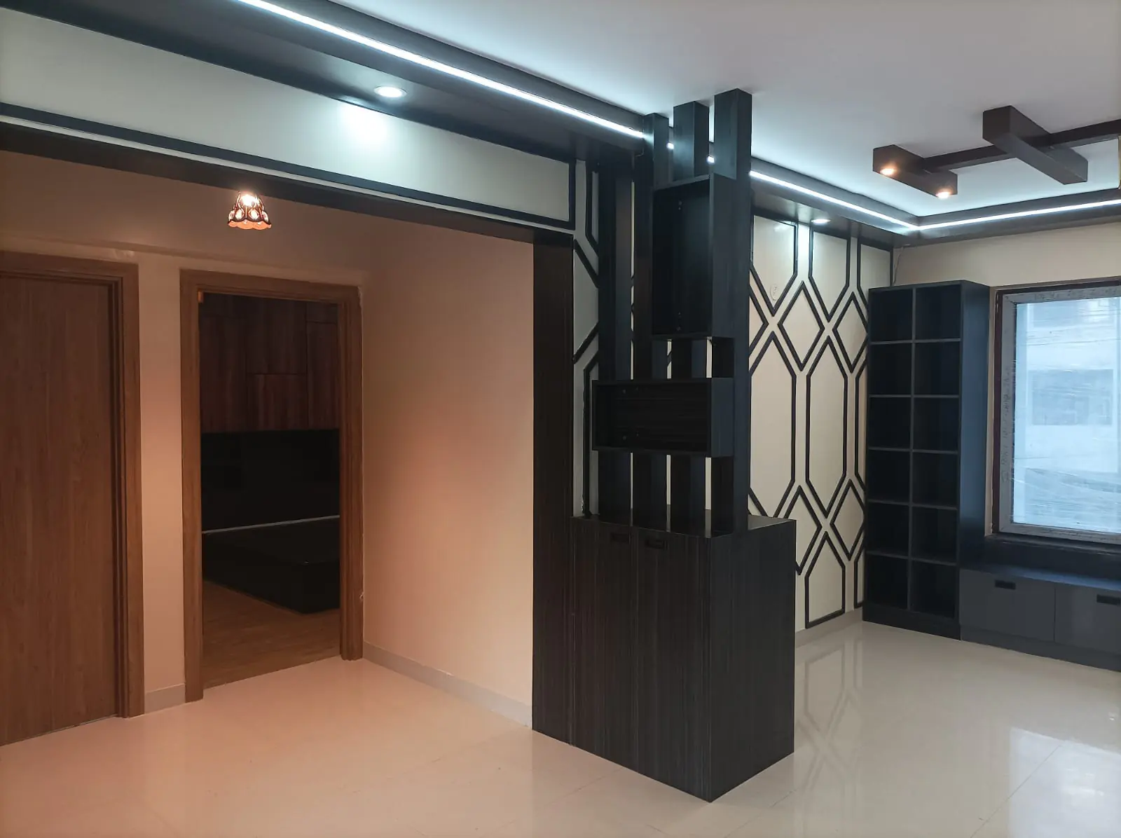 A completed Homecraft interior: custom dark joinery partition, lattice screen wall and integrated shelving.